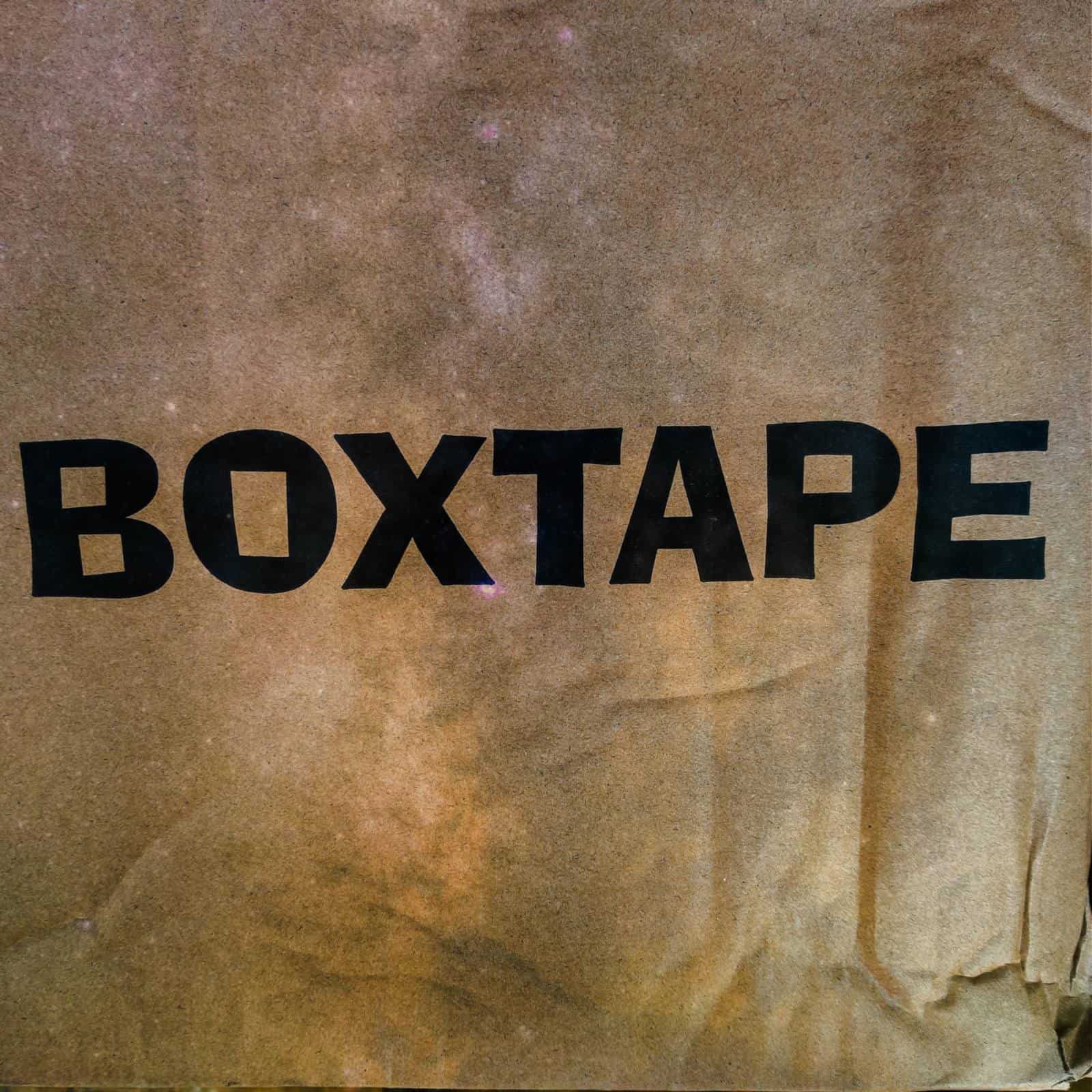 Close-up of a kraft carton printed BOXTAPE
